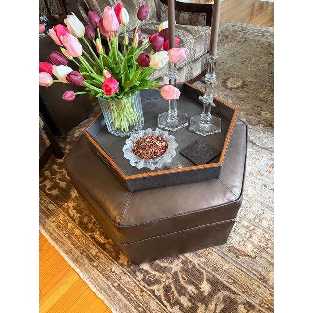 In a pearlized chocolate leather, this piece is an original Donghia ottoman. This piece was purchased directly from the...