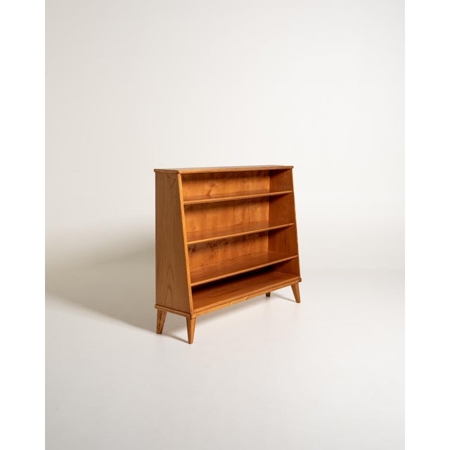 Scandinavian bookcase from the 1940s and 1950s made of elm, with an open structure, three shelves, and short, slightly...