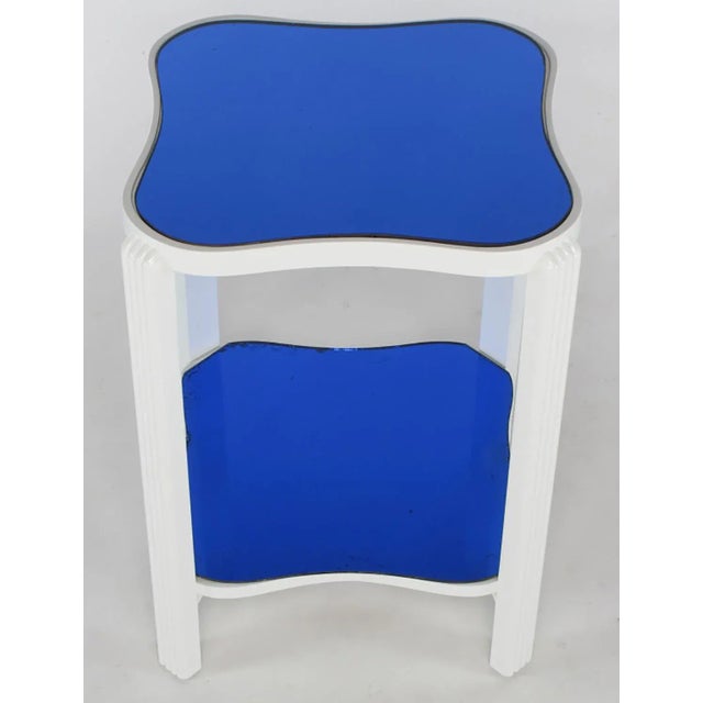 Restored gloss white lacquer over maple Art Deco end table with original blue mirrored top. Squared bow tie shaped two...