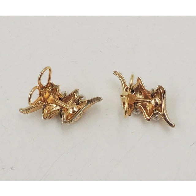 This is part of Chairish’s Costume Jewelry assortment. Goldtone faux-pearl clip back earrings. Marked "Napier." Made in...