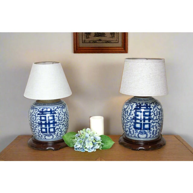 This exquisite pair of table lamps, crafted from antique Chinese ginger jars, exudes a timeless elegance and a touch of...