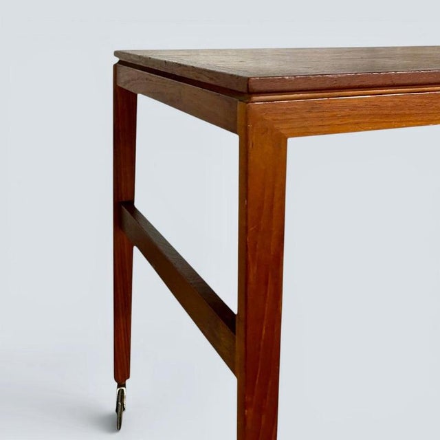 This Mid-Century Danish drinks trolley is constructed from teak, known for its durability and resistance to moisture....