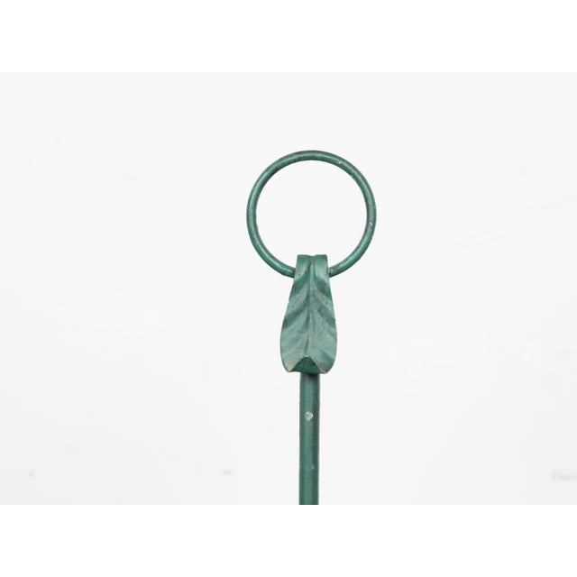 A vintage pair of American iron candle holders from the mid 20th century, with rabbit sculptures and green patina. Made in...