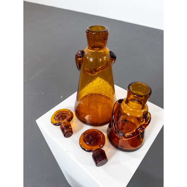Erik Höglund – Rare 1950s Hand-Blown Glass Carafe Set “People” This stunning set of two hand-blown glass carafes by...