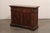 An Italian wooden credenza, with decorative geometric accents, from the mid 19th century. This antique buffet cabinet from...