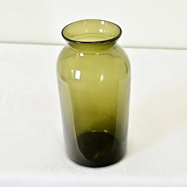 Dimensions: 11 ¾” H x 5 ¼” W x 5 ¼” D A wonderful green glass pickling or truffle jar from 18th century France. These...