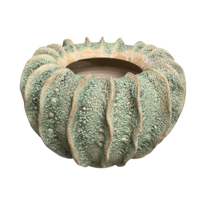 This exceptional vintage-inspired ceramic planter features a bold, globular form defined by deep, vertical undulating...