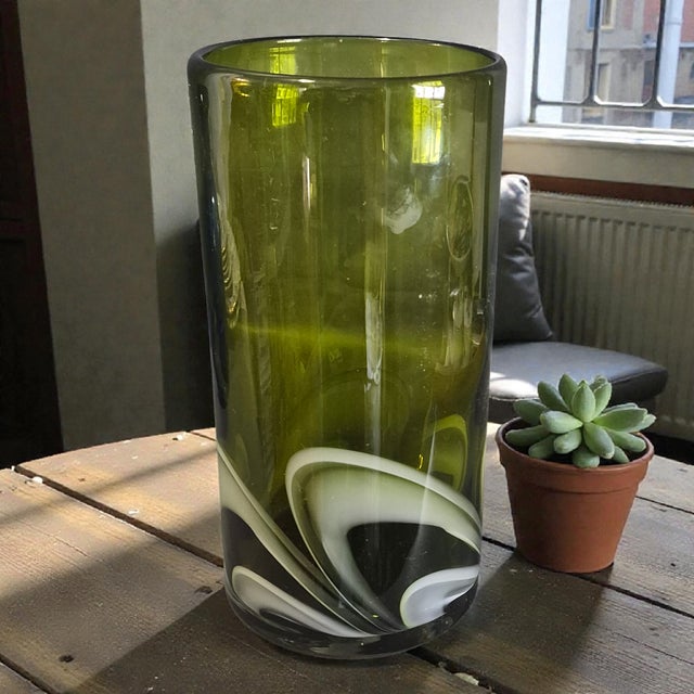 This Vintage Italian Mid-Century Modern Art Glass vase features a striking green and white swirl pattern, adding a touch...