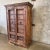 This 19th century handmade wooden antique armoire features iron braces and ring pulls on the doors. It is versatile and...