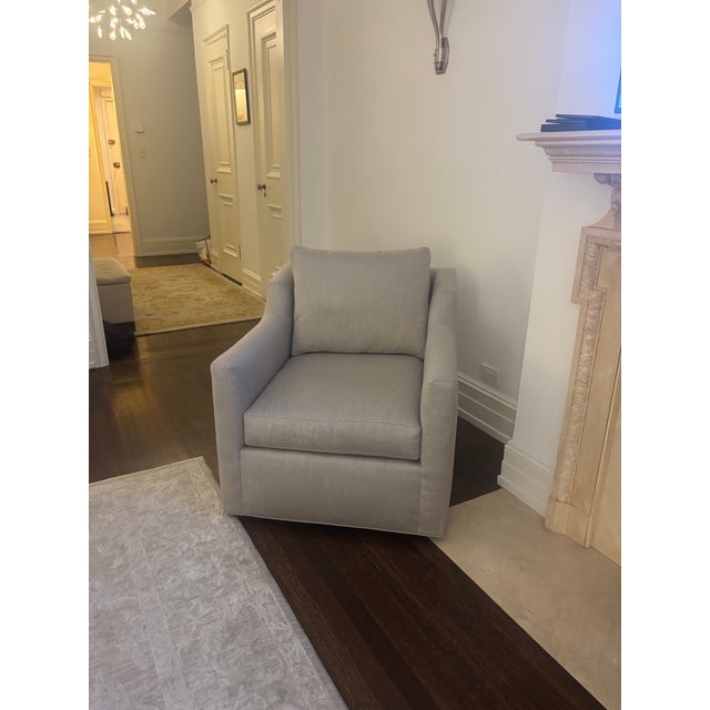 A traditional-style swivel chair with exceptional modern comfort. Sloping side wings and a crisp, tailored skirt recall...