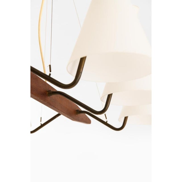 This rare ceiling lamp, designed by svend aage holm sørensen and produced by asea in sweden during the 1950s, exemplifies...