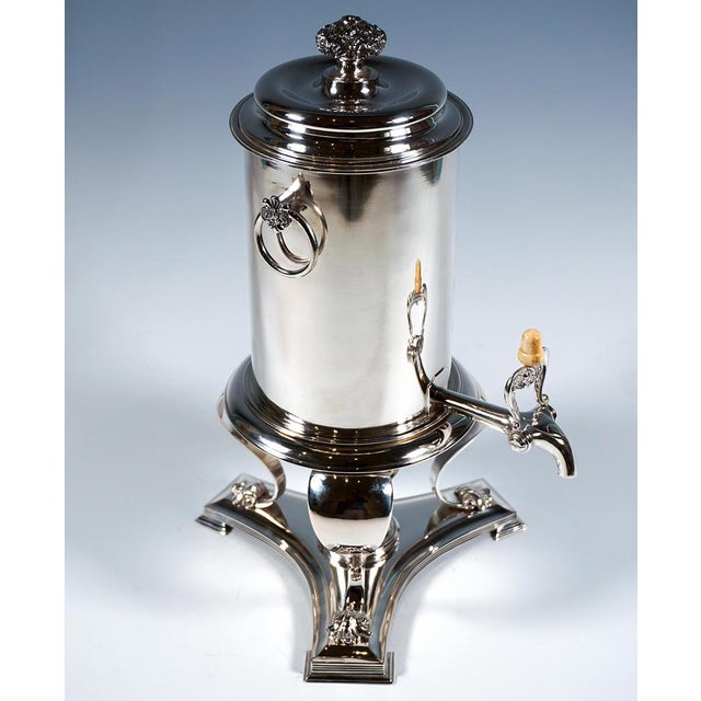 An elegant viennese silver samovar comprising a hot-water vessel with a lockable spout, a warmer and a burner. Cylindrical...