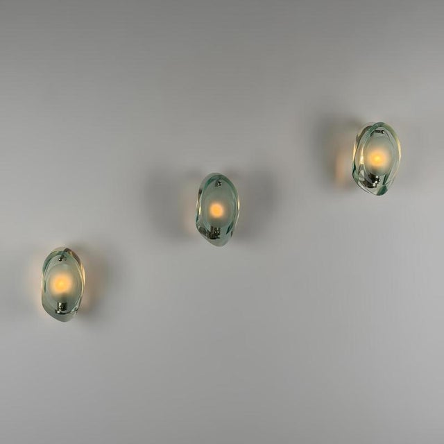 Elegant and highly sculptural set of three rare model 2093 wall lights designed by Max Ingrand and produced by Fontana...