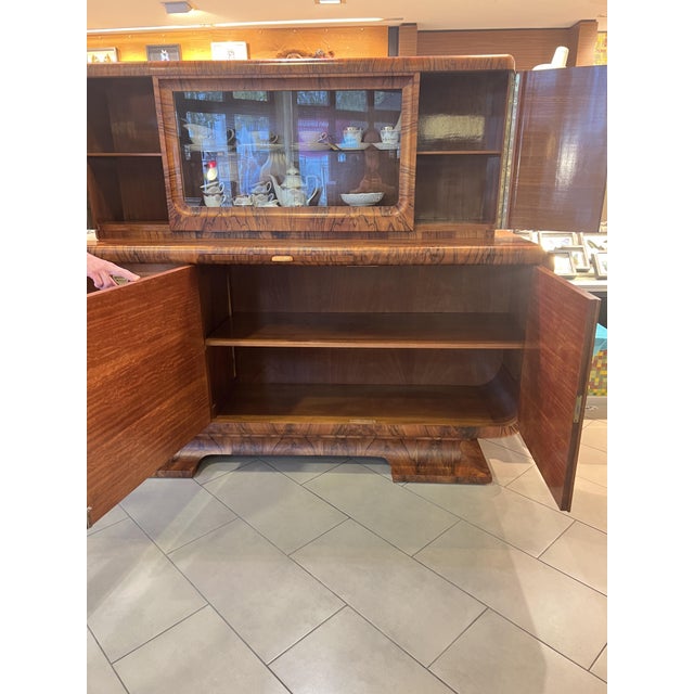 An exceptionally rare and monumental German Art Deco sideboard with its original vitrine top from the early Streamline...