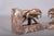 Pair of Art Deco bookends, dated to the 1930s. Each L-shaped red marble base with white veining carries two running...