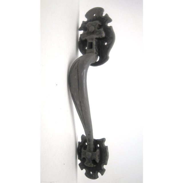 Arts & Crafts style door pull made of cast iron. The original mounting screws are not available. Good condition with...