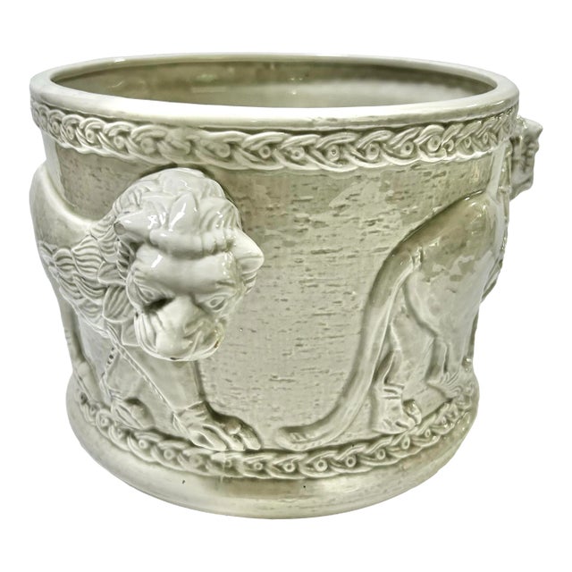 A rare 1977 Fitz & Floyd ceramic cachepot featuring dramatic three-dimensional lion heads projecting from each side and a...
