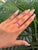 This half band ring features a 1.91 carat pear cut rubies, set in 14K yellow gold. Each measuring approximately 4.52 x...