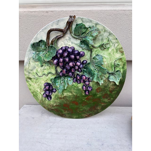 Colorful 19th century French Majolica grapes wall platter signed Longchamp terre de fer. The fruits are in high relief...