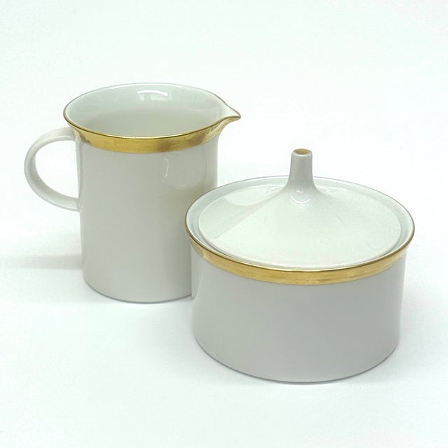 This vintage, delicate porcelain sugar bowl and creamer set, from the Kurfürstendamm design by Rosenthal, features a...
