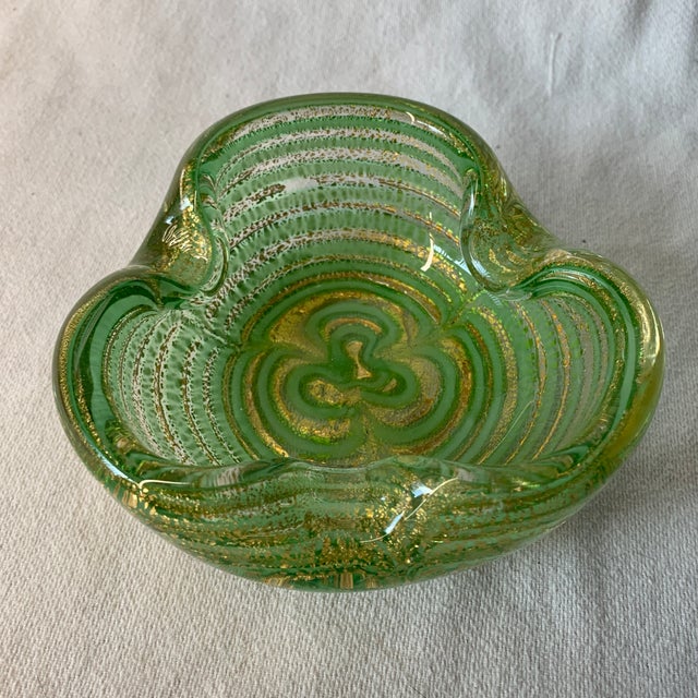 This is a vintage Murano green and gold aventurine "Zebrati" or "Graffito" art glass bowl or ashtray by Barovier & Toso,...