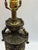Vintage Neoclassical urn-style table lamp featuring an ornate cast metal body with relief scrollwork, acanthus leaf...