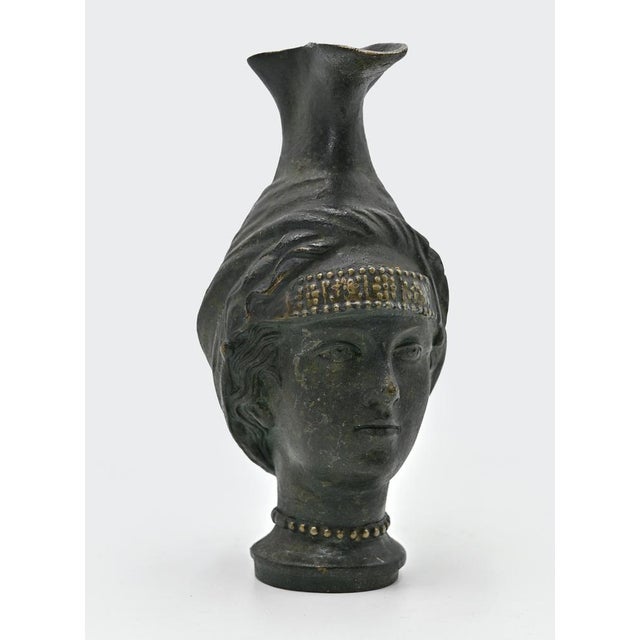 Bronze jug is an original objectrealized by anonymous artist in the early 20th Century. A jug realized in ancient manner,...
