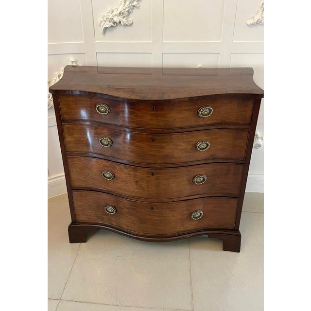 Antique George lII 18th Century quality figured mahogany serpentine chest of drawers having a quality figured mahogany...