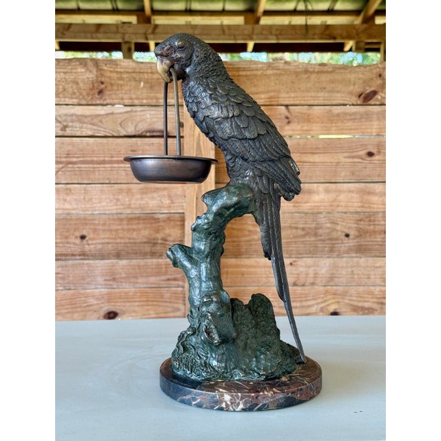 A striking mid-20th century bronze parrot sculpture, finely cast with excellent detail and mounted on a variegated marble...