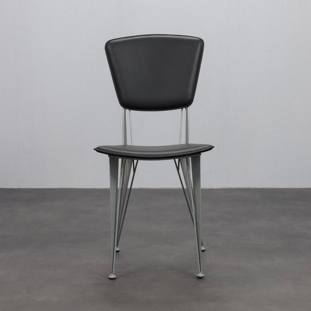 A refined set of four t38 dining chairs designed by studio archirivolto for fasem in the 1980s. Combining clean...