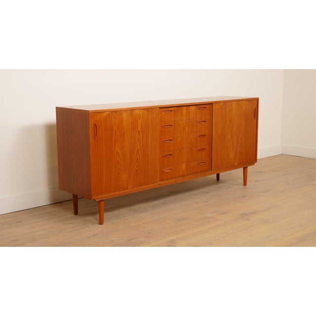 This vintage cabinet immediately stands out for its beautiful design; the drawers and doors have minimalist wooden...