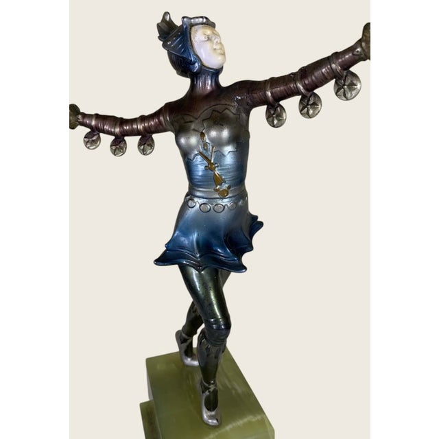 11.25” high, 9” fingertip to fingertip, cold painted in polychrome colors of silver, bronze, blue and black, a wonderful...