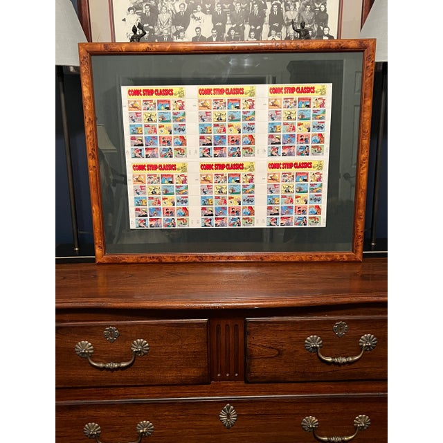 Six mint sheets of Comic Book Classics stamps from the USPS. These colorful stamps are framed in a burl wood frame and...