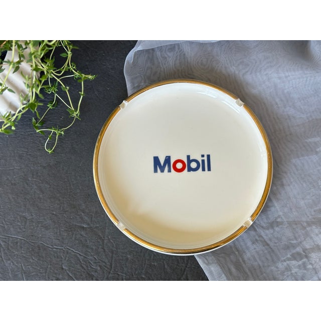 Produced for Mobil by Incentives for Industry, Inc, this vintage ceramic ashtray is a trinket from the oil company's 1960s...