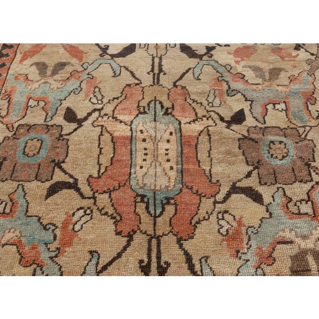 An early 20th century Sultanabad carpet from West Persia, the maize field with a split-leaf, palmette and vinery trellis...