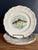 Three French faience plates from the "Indre" fish service by Sarreguemines, each decorated with a different freshwater...