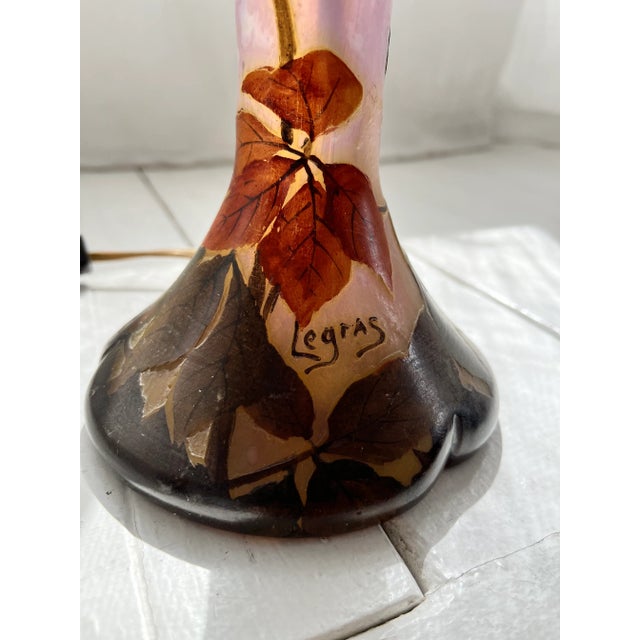 Legras, France. Large Art Nouveau table lamp in mouth-blown art glass carved with motifs of flowers and foliage. Early...