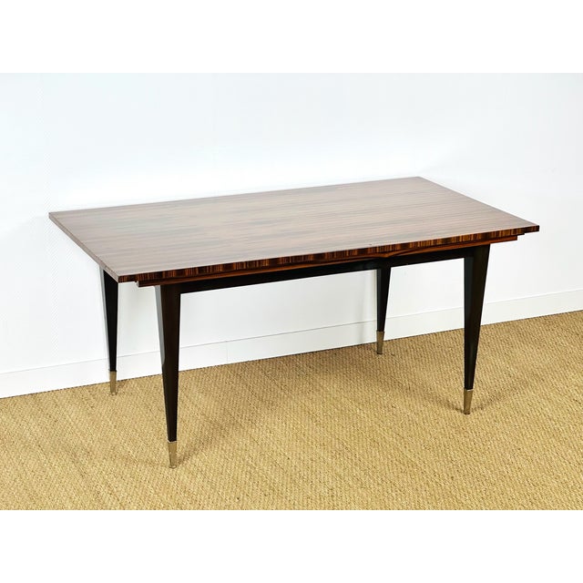 Stunning vintage modernist table from the 1950s, recognizable by its zebrawood veneer, a precious wood prized for its...