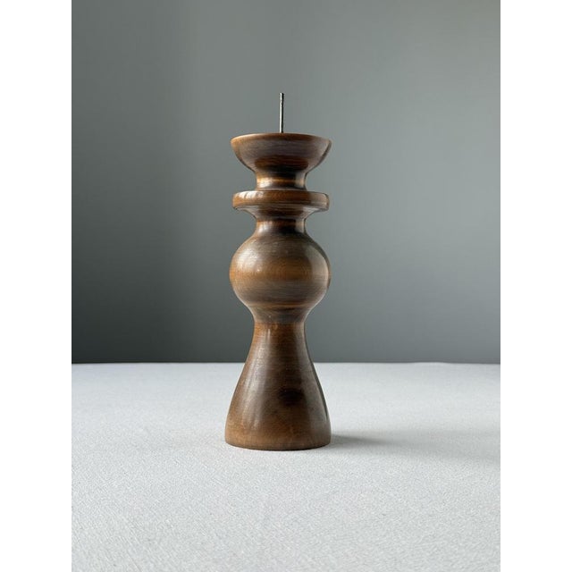 Sculptural turned wooden candlestick produced in Hungary during the mid-20th century. The piece features an elegant...
