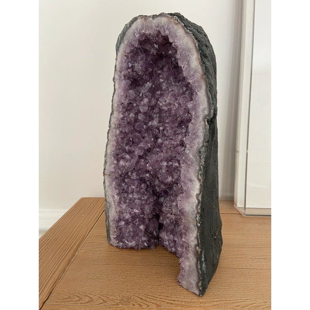 A beautiful large sculptural amethyst geode. The purples from from deep to lavender with black flecks throughout. This is...
