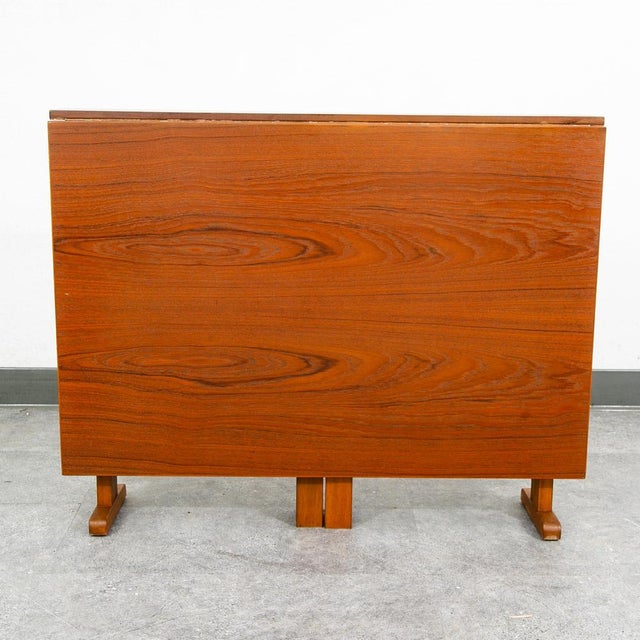 Outstanding teak drop/gate leg leaf dining table. This table can expand into a table that seats 6 when both flaps are...