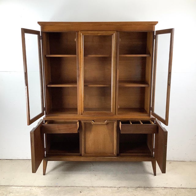 This walnut mid-century china cabinet offers the perfect balance of display and storage in a streamlined design. Crafted...