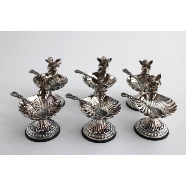 Gorgeous Set of 6 heavily plated silver salt cellars and spoons from Pedro Duran of Spain. Each cherub is seated atop a...