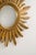 This vintage mid-century modern convex sunburst wall mirror is a classic example of the Hollywood Regency style. Crafted...