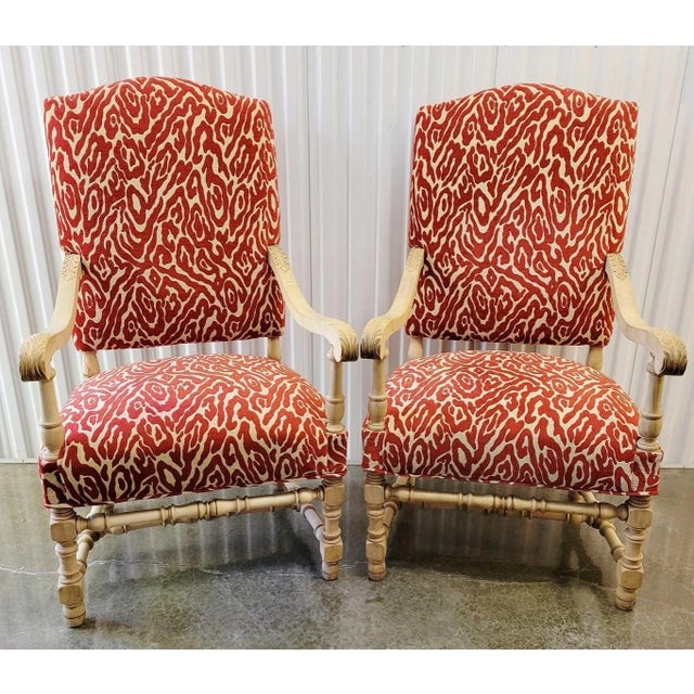 A striking pair of 20th C French Louis XIII Revival armchairs in bleached oak, newly upholstered in a bold red cut velvet...
