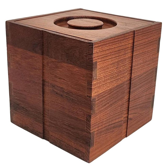 Offered is a cube shaped ice bucket and lid in teak wood made by Kalmar in the 1970s. Features a carved knob lid, a brown...