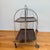 A wonderful example of 1970s German design, this vintage Bremshey folding bar cart combines sleek chrome tubing with two...