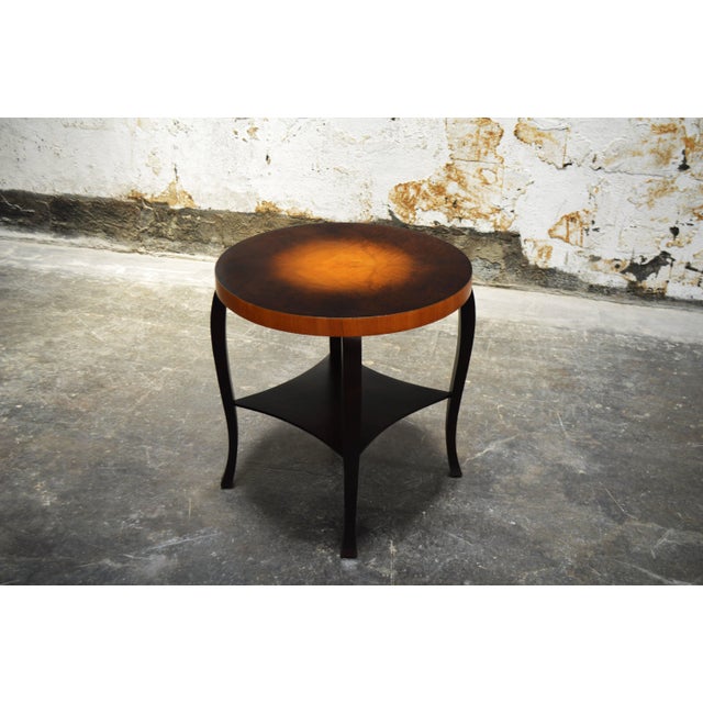 Handsome Swedish Art Deco side table of dark flame birch and golden elm. Beautiful gradient top trimmed with contrasting...