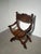 Beautiful antique Savonarola-style chair in solid oak, richly decorated with detailed hand carvings. This piece features...