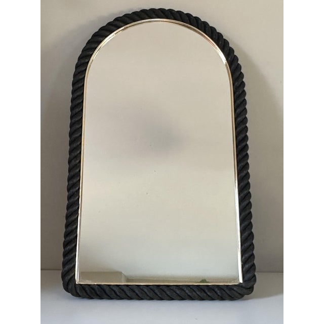 Very pretty mirror surrounded by black rope, elegant and decorative, good general condition, some slight spots on the...